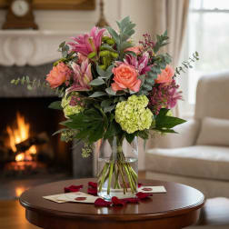 Bouquet of pink and coral flowers in a clear glass vase
