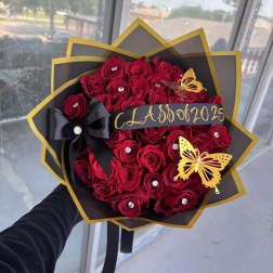 Bouquet of red roses with black and gold wrapping and butterfly accents