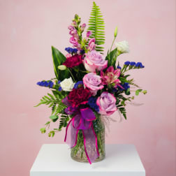 Bouquet of pink and white roses in a glass vase