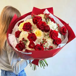 Large bouquet of red and cream roses wrapped in red paper