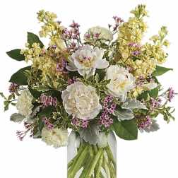 White and pale yellow flowers in a clear glass vase