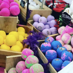 Colorful bath bombs arranged in wooden crates