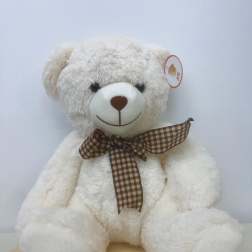 White teddy bear with a brown plaid ribbon bow