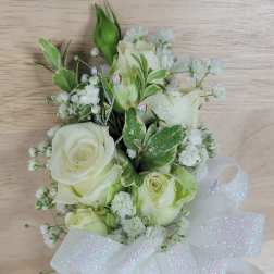 White rose bouquet with baby's breath and a large sheer ribbon