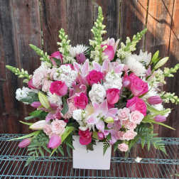 Pink and white mixed flower arrangement in a white vase