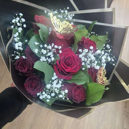 Bouquet of red roses with baby's breath in black wrap