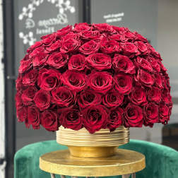 Large dome of red roses in a gold vase