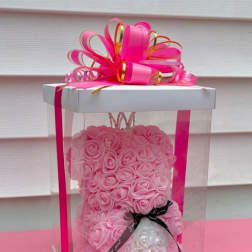 Pink rose teddy bear in a clear gift box with a ribbon bow