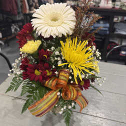 Mixed bouquet with gerbera daisies and chrysanthemums in a ribboned vase