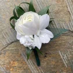 Small white floral boutonniere with clustered blooms and green-wrapped stem
