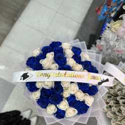 Bouquet of blue and white roses with a graduation ribbon