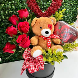 Red roses with a teddy bear in a black box and a heart decoration