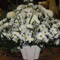Large white floral arrangement in a textured white container