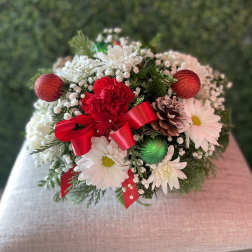 Holiday bouquet with white daisies, red carnations, and a red ribbon