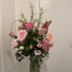 Pink mixed flower arrangement in a clear glass vase