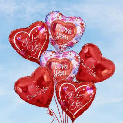 Cluster of heart-shaped red and pink balloons with love messages