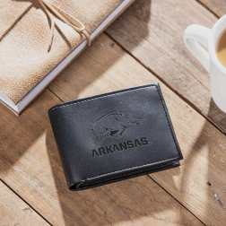 Black wallet with Arkansas Razorbacks logo on a wooden table