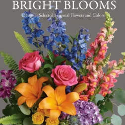 Bright mixed bouquet with roses, lilies, and tall blue and pink blooms