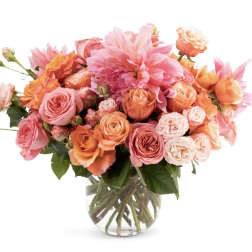 Pink and orange roses with a large pink dahlia in a glass vase