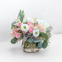 Pink and white bouquet in a clear glass vase