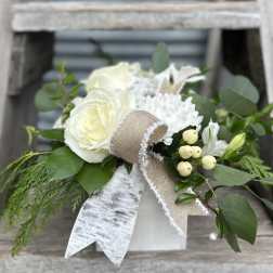 White rose bouquet with greenery and a burlap ribbon