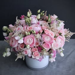 Pink and white flower arrangement in a white vase