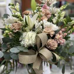 Bouquet of white and blush flowers with a tan ribbon bow