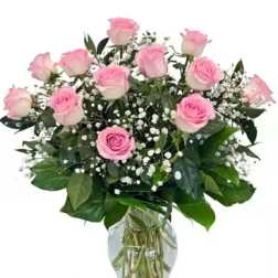 Pink roses and baby's breath in a clear glass vase