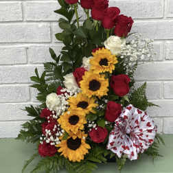 Tall bouquet of red and white roses with sunflowers and a heart ribbon