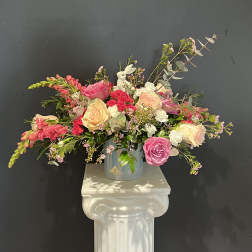 Mixed pink and cream rose arrangement in a glass vase
