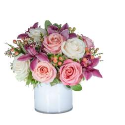 Pink and white roses with purple orchids in a glass vase