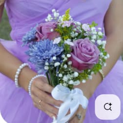 Bridal bouquet of lavender roses and blue flowers with white ribbon