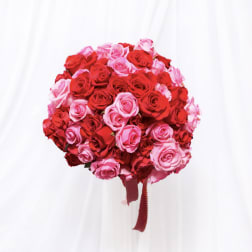 Round bouquet of red and pink roses with ribbon tails