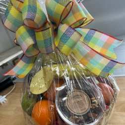 Gift basket with fruit and a large plaid ribbon