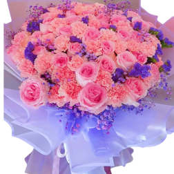 Large bouquet of pink roses and carnations with purple filler flowers