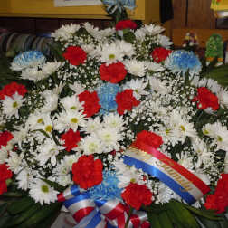 Large red, white, and blue floral wreath with ribbon