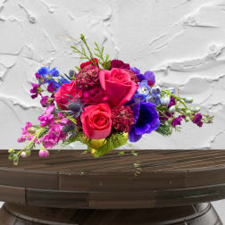 Bright mixed bouquet with pink roses and purple flowers