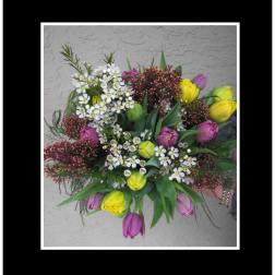 Bouquet of yellow and purple tulips with small white blossoms