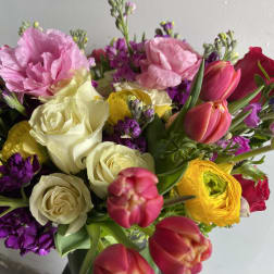 Mixed bouquet with roses, tulips, and pink blooms in bright colors