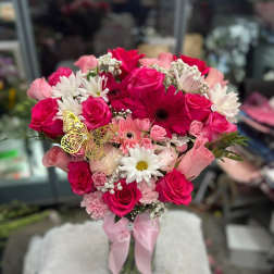 Pink and white bouquet of roses and daisies with a butterfly pick