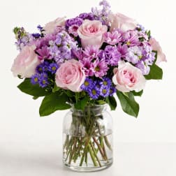 Pink and purple mixed bouquet in a clear glass vase