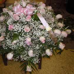 Large bouquet of pale pink roses with baby's breath and a pink ribbon