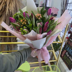 Bouquet of pink tulips wrapped in white and pink paper