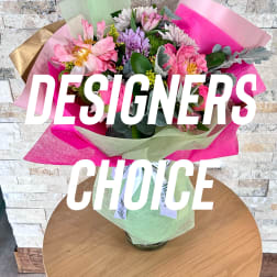 Bouquet of pink and purple flowers wrapped in bright paper