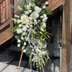 Tall white floral standing spray on an easel