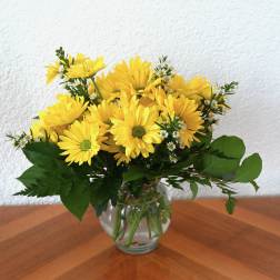Yellow daisy bouquet in a clear glass vase