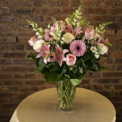 Pink and white mixed flower bouquet in a clear glass vase