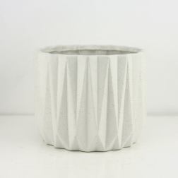 White faceted ceramic planter pot on a plain background