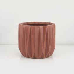 Textured terracotta-colored planter pot on a white background