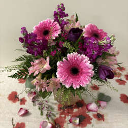 Pink and purple mixed bouquet in a glass vase